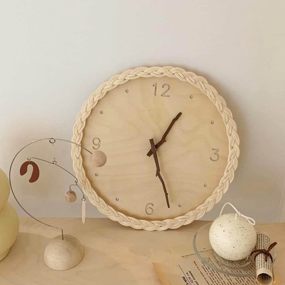 Round wall clock with a braided rattan rim and beige dial
