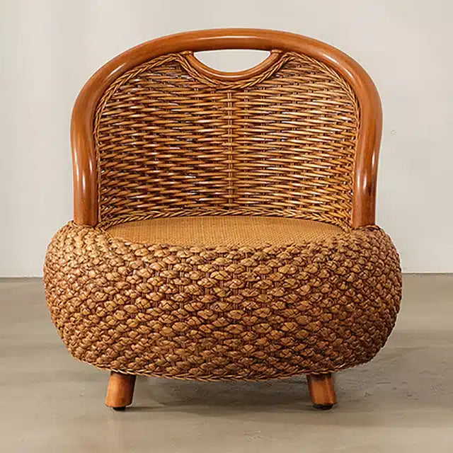 Compact low armchair with rounded shapes, hand woven in deep brown rattan