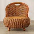 Compact low armchair with rounded shapes, hand woven in deep brown rattan
