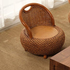 Compact low armchair with rounded shapes, hand woven in deep brown rattan