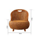 Compact low armchair with rounded shapes, hand woven in deep brown rattan