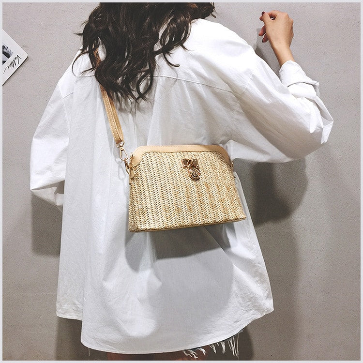 Rounded brown woven basket bag with a gold chain strap