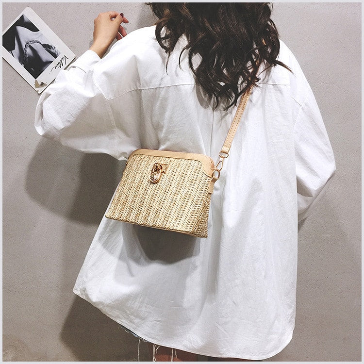 Rounded brown woven basket bag with a gold chain strap