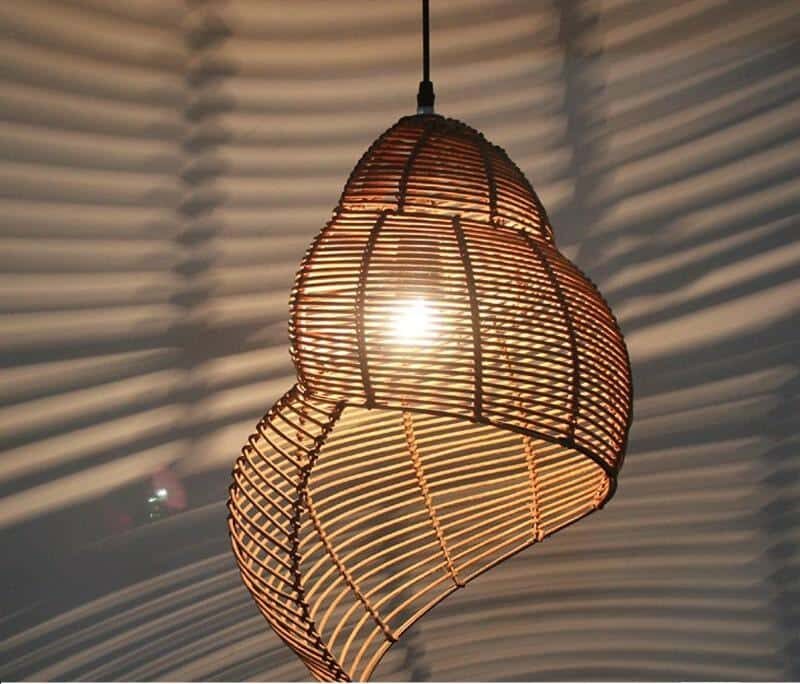 Brown open weave rattan pendant shaped like a conch seashell