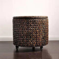 Brown hand woven rattan footstool on casters with a lift off lid