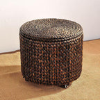 Brown hand woven rattan footstool on casters with a lift off lid