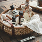 Round brown rattan storage tray with stitched leather handles
