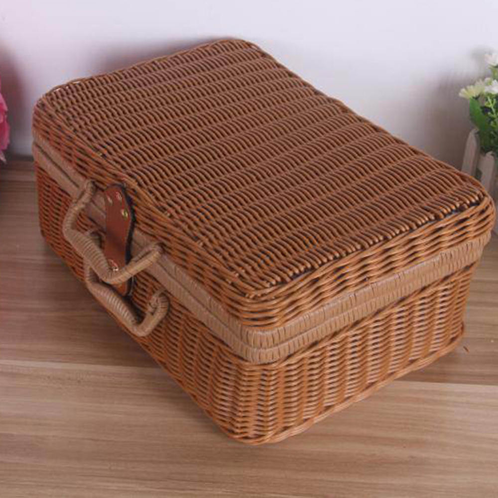 Small brown woven rattan box shaped like a retro suitcase with straps