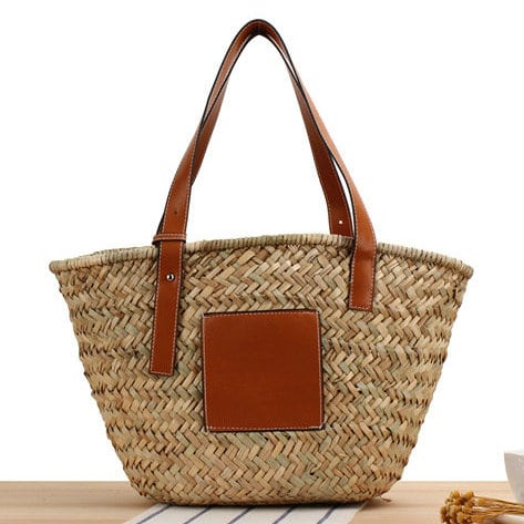 Brown hand woven raffia straw handbag with two sturdy handles