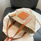 Brown hand woven raffia straw handbag with two sturdy handles