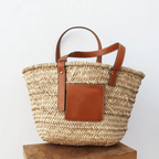 Brown hand woven raffia straw handbag with two sturdy handles