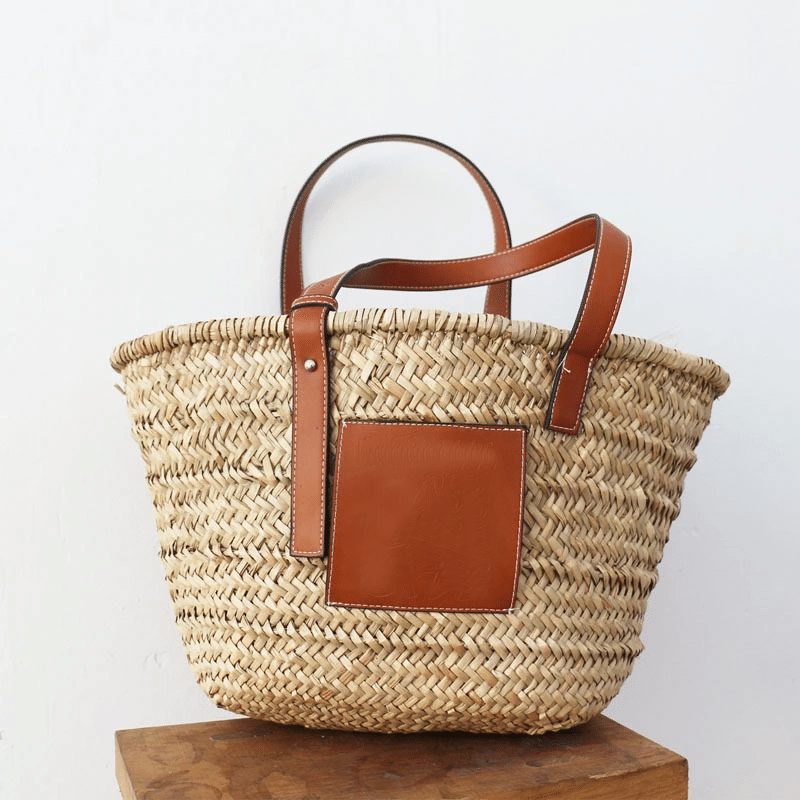 Brown hand woven raffia straw handbag with two sturdy handles