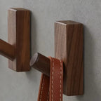 Small brown wood wall hook with visible grain
