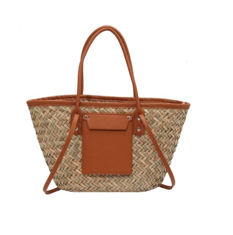Structured brown woven rattan beach bag with a handle and shoulder strap