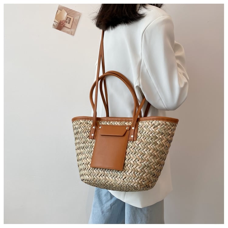 Structured brown woven rattan beach bag with a handle and shoulder strap