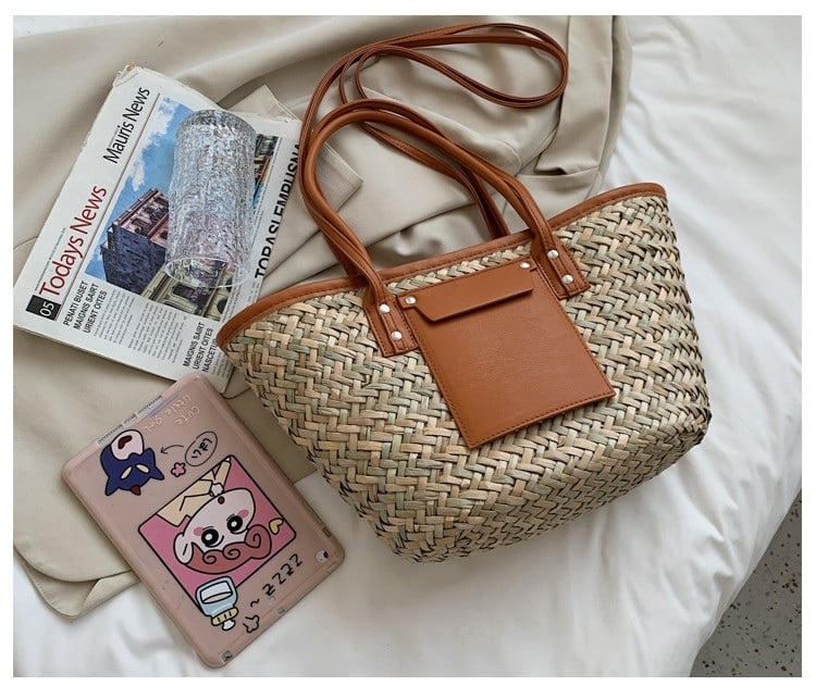 Structured brown woven rattan beach bag with a handle and shoulder strap