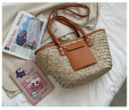 Structured brown woven rattan beach bag with a handle and shoulder strap