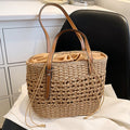 Caramel brown woven straw beach handbag with a braided cord strap
