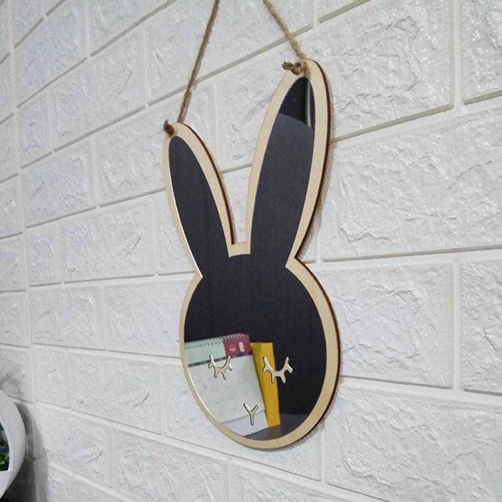 Bunny shaped wooden wall mirror hanging on a white brick wall