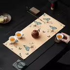 Woven bamboo mat with deep blue butterflies on a natural cream background
