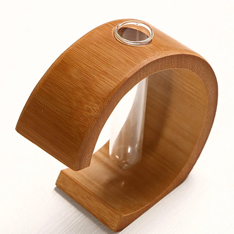 C shaped bamboo stand holding a clear glass test tube