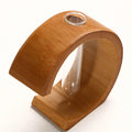 C shaped bamboo stand holding a clear glass test tube