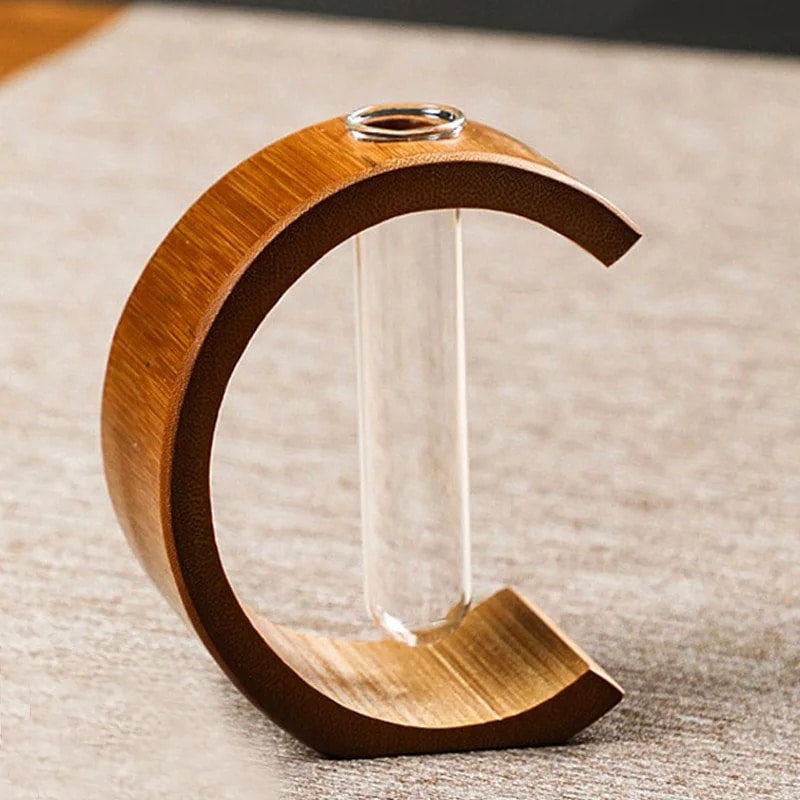 C shaped bamboo stand holding a clear glass test tube