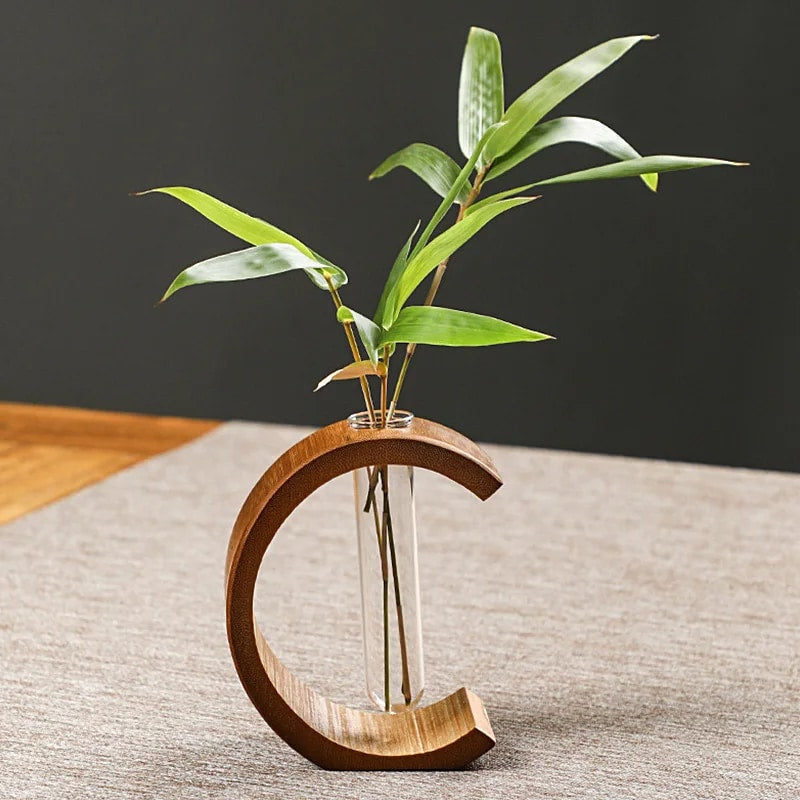 C shaped bamboo stand holding a clear glass test tube