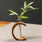 C shaped bamboo stand holding a clear glass test tube