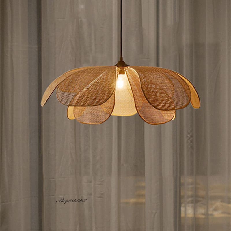 Flower shaped pendant light with woven cane petals over a sofa