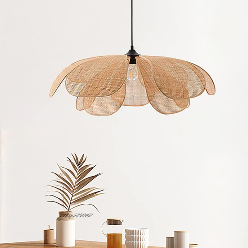 Flower shaped pendant light with woven cane petals over a sofa