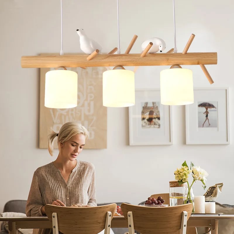 Wooden branch pendant light with small carved birds perched on it