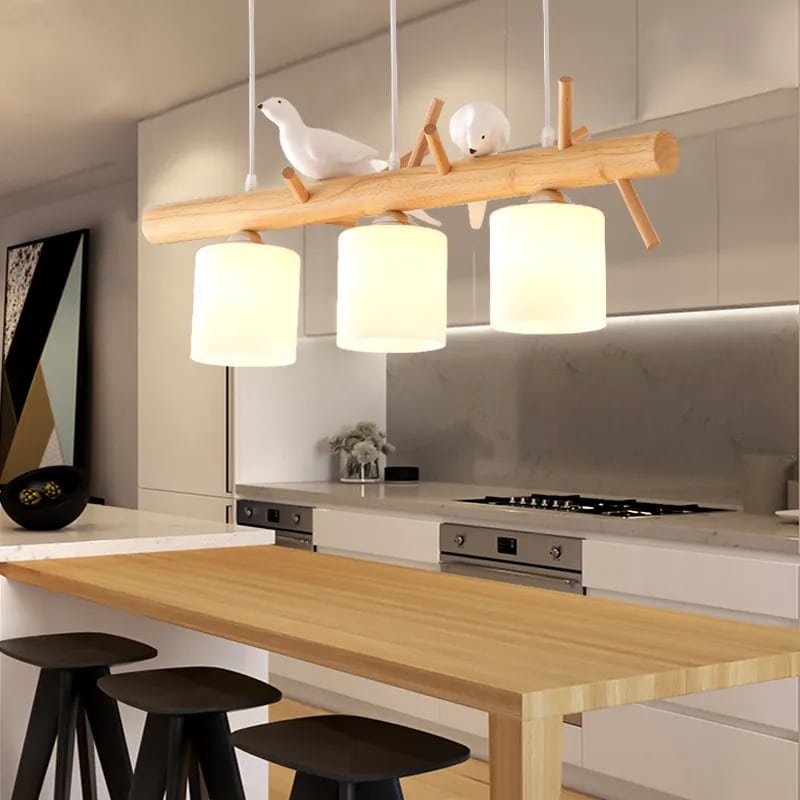 Wooden branch pendant light with small carved birds perched on it