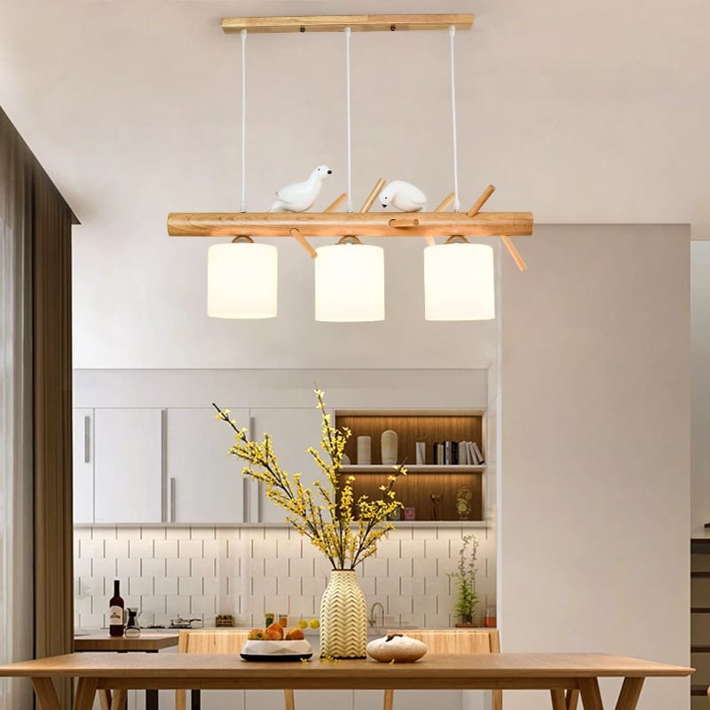 Wooden branch pendant light with small carved birds perched on it