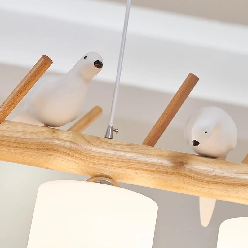 Wooden branch pendant light with small carved birds perched on it