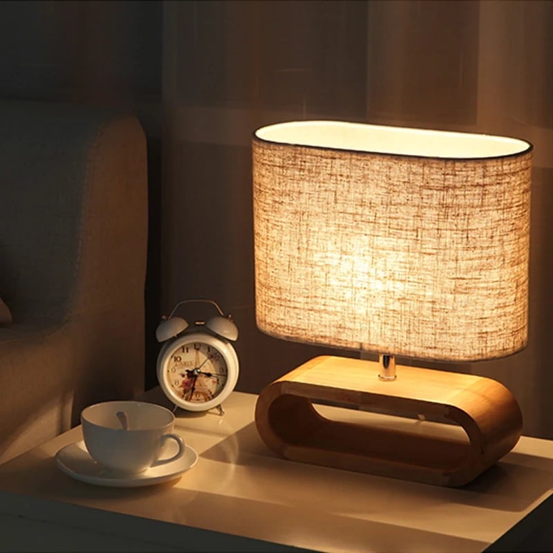 Chic rounded bedside lamp with a brown wood base and yellow fabric shade