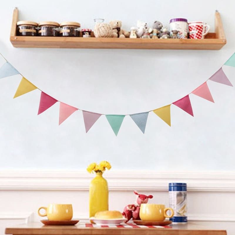 Colorful fabric bunting and a macrame photo display with clips