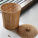 Compact woven rattan trash can with a fitted lid