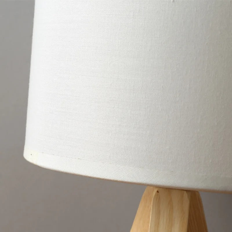 Slender contemporary bedside lamp in light natural wood