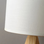 Slender contemporary bedside lamp in light natural wood