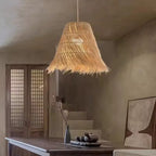 Modern pendant light with hand woven rattan arches radiating around the diffuser