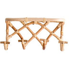 Crisscross woven rattan wall coat rack with four hooks and a top shelf
