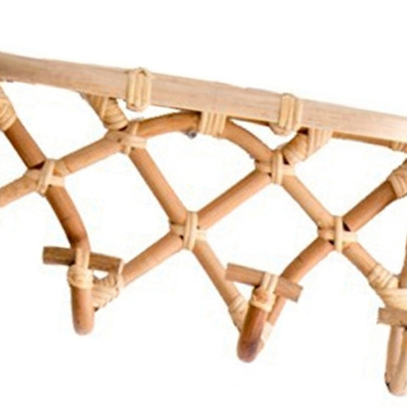 Crisscross woven rattan wall coat rack with four hooks and a top shelf