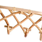 Crisscross woven rattan wall coat rack with four hooks and a top shelf