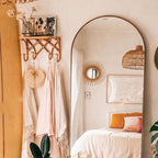 Crisscross woven rattan wall coat rack with four hooks and a top shelf