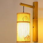 Cylinder bamboo wall sconce with painted motif on a bamboo arm