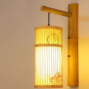 Cylinder bamboo wall sconce with painted motif on a bamboo arm