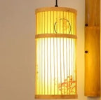 Cylinder bamboo wall sconce with painted motif on a bamboo arm