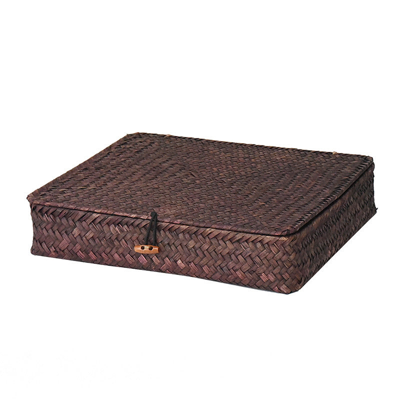 Low flat storage box hand woven in dark natural rattan with a lid