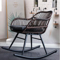 Rocking chair hand woven in deep brown rattan with a dense regular weave